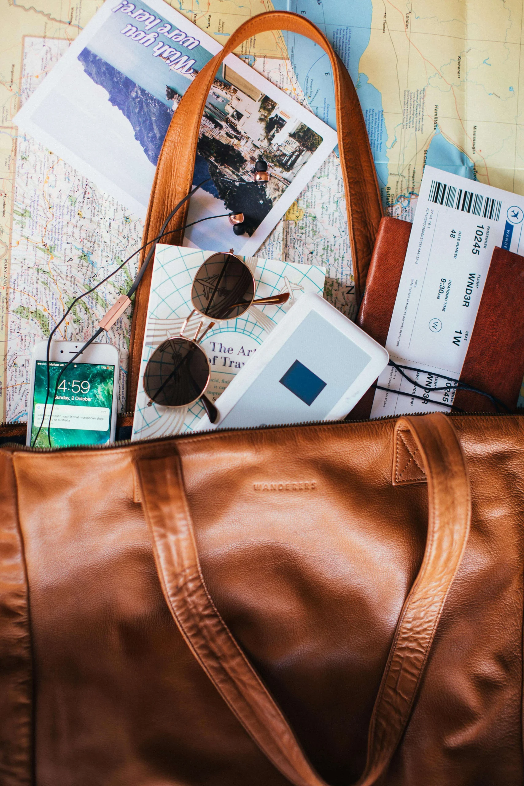 Brown leather bag with travel items spilling out